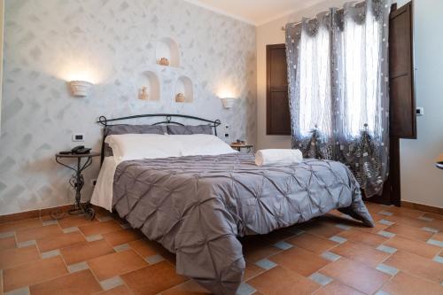 a bedroom with a large bed in a room at Il Marchese Hotel & Spa in Sciacca