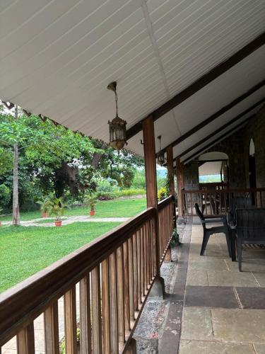 a porch with a wooden deck with a chandelier at Madhuvan Retreat Resort Amba in Chandoli