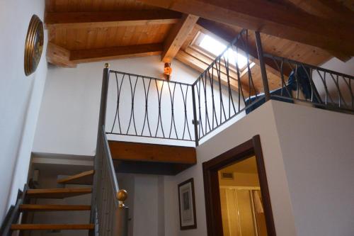 a staircase in a house with wooden ceilings at Hotel Ristorante Italia in Certosa di Pavia
