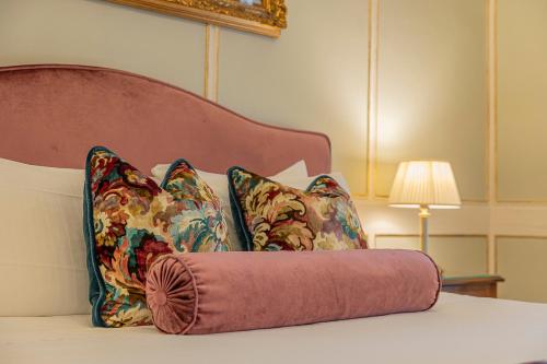 a bed with two pillows and a towel on it at Palazzo Monga Boutique Guesthouse in Verona