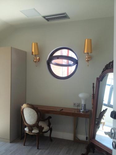 a room with a wooden desk and a window at Hotel Art Santander in Santander
