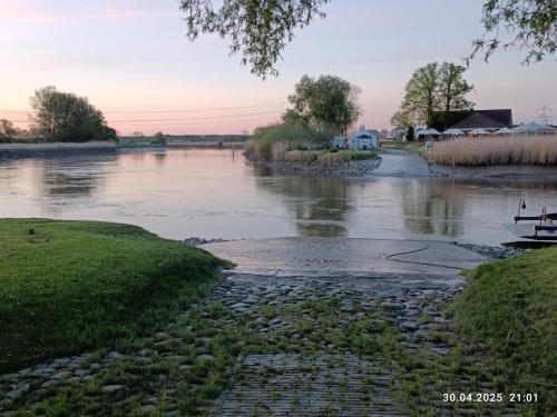 a view of a river at sunset at Ediths Haus in Rhauderfehn