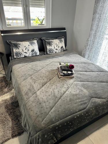 a bed with a tray with a flower on it at 4SeasonsApartment in Kardítsa