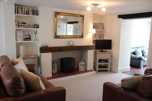 a living room with a couch and a fireplace at Stylish, central Beaumaris cottage in Beaumaris