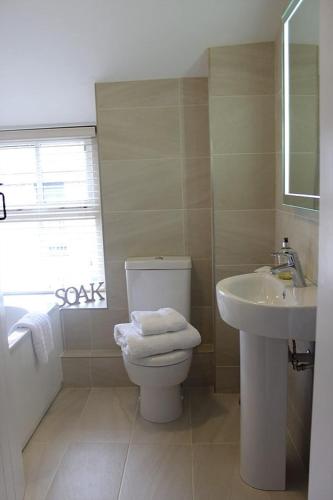 a bathroom with a toilet and a sink at Stylish, central Beaumaris cottage in Beaumaris
