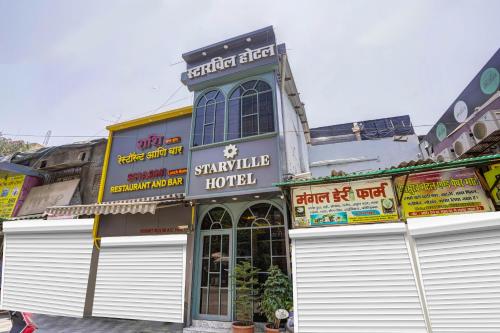 a building with white garage doors on a street at Starville Hotel Andheri MIDC in Mumbai