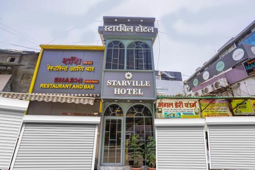 a building with doors and signs in a city at Starville Hotel Andheri MIDC in Mumbai