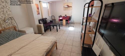 a bedroom with a bed and a dining room with a table at Spacious 110m2 2BR Basement Retreat, Jacuzzi, Table Tennis & Garden Access in Malmö
