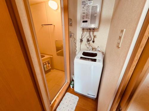 a small kitchen with a stove and a refrigerator at Choyo 103 in Sapporo