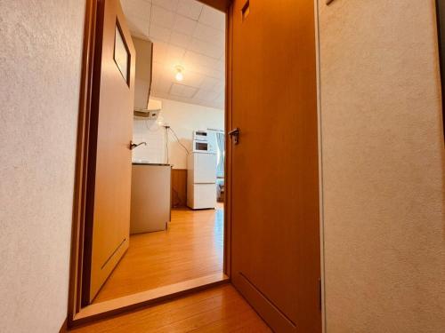 an open door to a kitchen in a room at Choyo 103 in Sapporo
