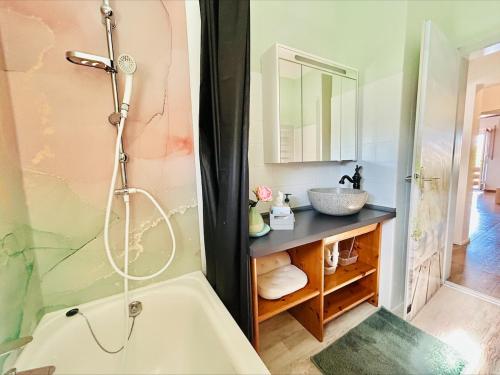 a bathroom with a tub and a sink and a shower at Inmitten des Dorflebens - Rheinfelden-Nollingen in Nollingen