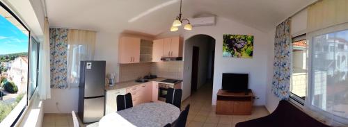 a kitchen with a large window and a room with a kitchen at Villa Marijeta Hvar in Hvar