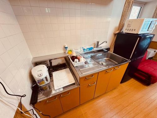 a kitchen with a sink and a counter top at Choyo 105 in Sapporo