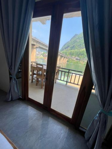 a room with a window with a view of a bridge at Cam u view Guest House in Nongkhiaw
