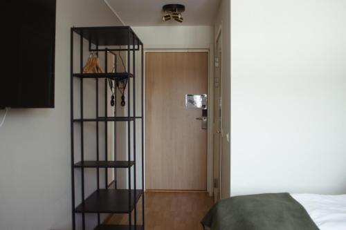 a room with a book shelf next to a door at Hornavan Hotell in Arjeplog