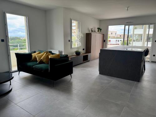 a living room with a couch and a table at Skyline Rooftop Swim Spa in Montpellier
