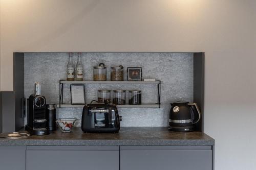 a kitchen with a counter with a toaster and a microwave at Strönhof Kampen in Kampen