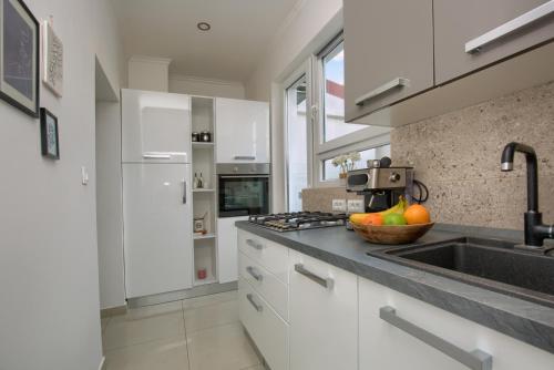 a kitchen with a sink and a counter top at Augustus in Pula