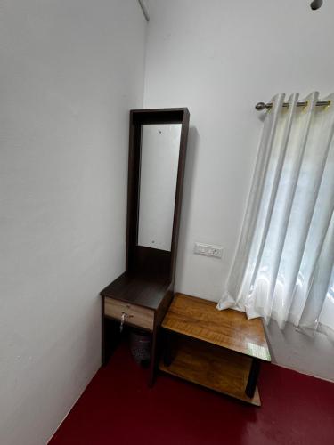 a mirror on a dresser next to a window at Beach Heaven by Azure Heaven Holidays Pvt ltd in Mararikulam
