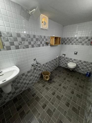 a bathroom with a sink and a toilet at Beach Heaven by Azure Heaven Holidays Pvt ltd in Mararikulam
