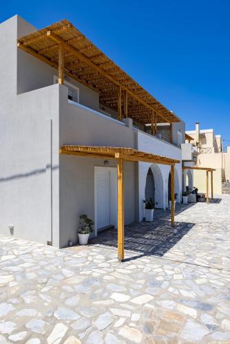 a white building with awning on the side of it at Vivianna's View in Azolimnos