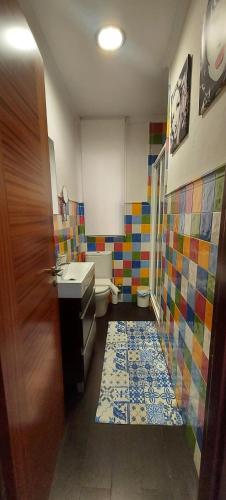 a bathroom with a sink and a colorful tile floor at Oasis de Playa O Grove in Virxe das Mareas