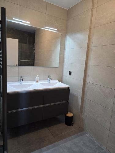 a bathroom with a sink and a mirror at Skyline Rooftop Swim Spa in Montpellier