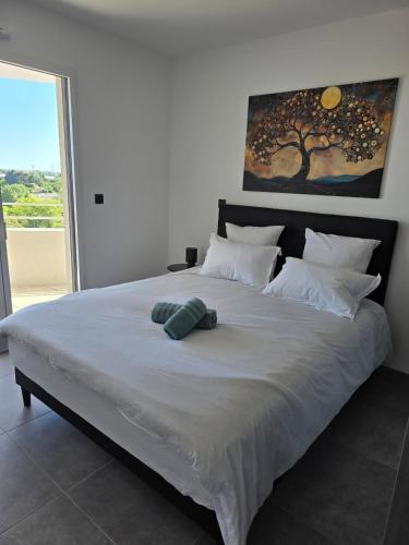 a large white bed with two pillows on it at Skyline Rooftop Swim Spa in Montpellier