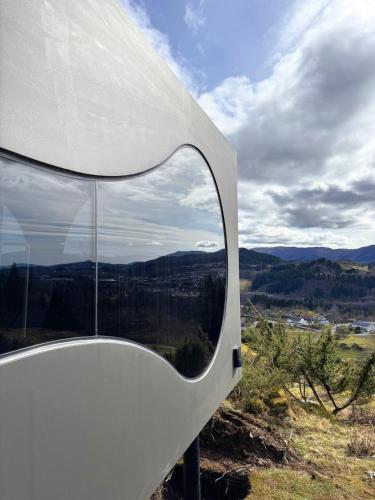 a mirror on the side of a rv with a view at Birdbox Bergen in Bergen