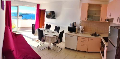 a kitchen with a table and a kitchen with a balcony at Villa Marijeta Hvar in Hvar