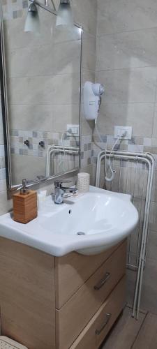 a bathroom with a white sink and a mirror at Il Canto delle Sirene in Vieste