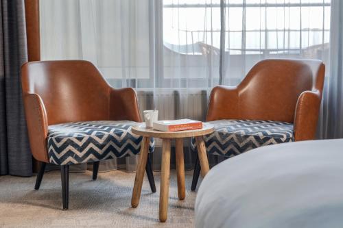 two chairs and a table in a hotel room at Paal 8 Hotel aan Zee in West aan Zee