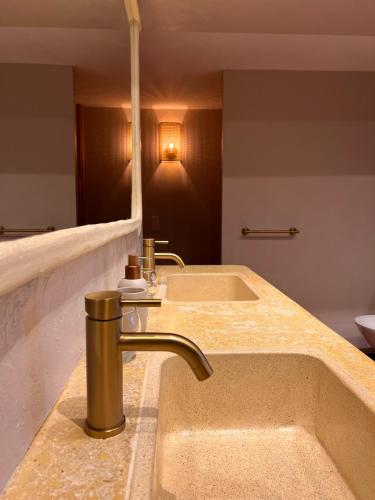 a bathroom with a sink and a large mirror at Le Moulin de Montségur in Montségur-sur-Lauzon