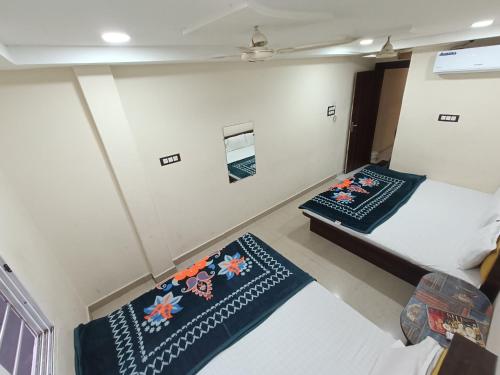 a bedroom with two beds and two pillows at New SHIPRA TOWER in Ujjain