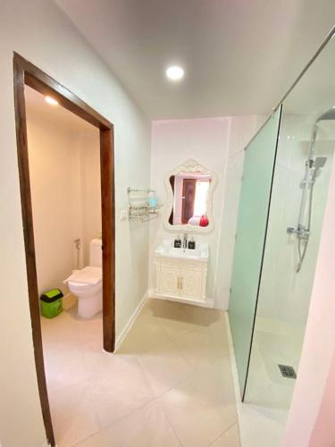 a bathroom with a toilet and a sink and a shower at Luang Prabang Golden Lotus Villa River View in Luang Prabang