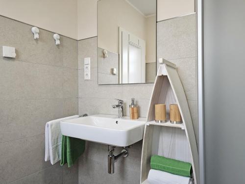 a bathroom with a sink and a mirror at Ferienhaus Xena in Biendorf