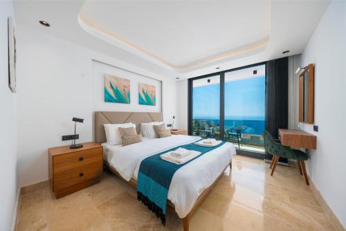 a bedroom with a bed and a large window at Villa turquoise in Kalkan