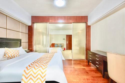 a hotel room with a bed and a mirror at 寓洣公寓佛山铂顿祖庙岭南天地店 in Foshan
