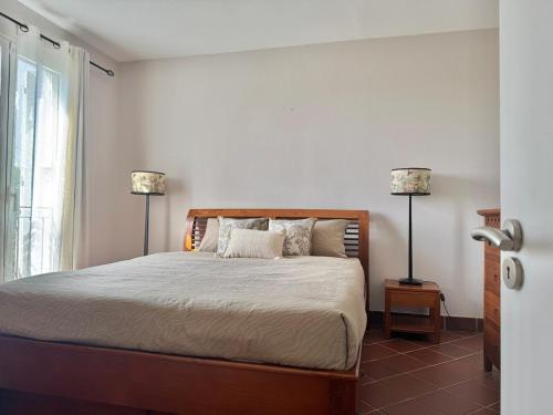 a bedroom with a large bed with two lamps at Harmony Villa - Port Chambly in Mauritius