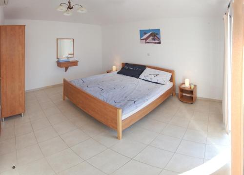 a bedroom with a bed with two candles on it at Villa Marijeta Hvar in Hvar