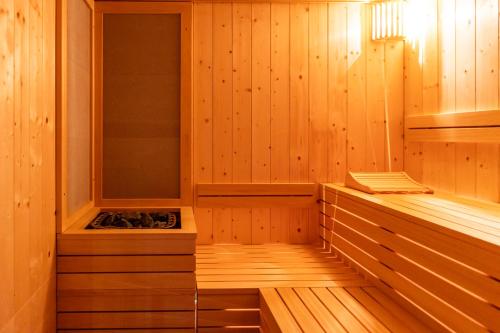 a sauna with wood paneled walls and a stove at Hotel Europa in Sirmione