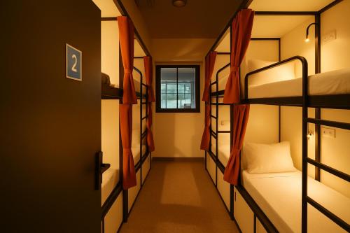 a corridor of a dorm room with bunk beds at The Metrostay Opposite New Delhi Railway Station, Above Metro, 20 Mins From IGI Airport in New Delhi