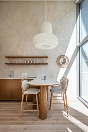 a dining room with a table and two chairs at Japandi style luxury penthouse in Palanga