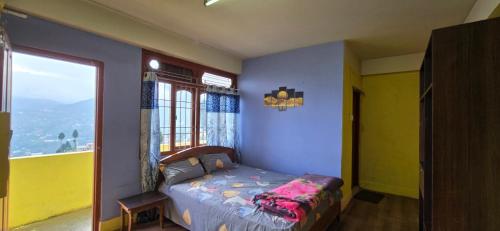 a bedroom with a bed in a room with a window at Holiday hills homestay in Bomdila