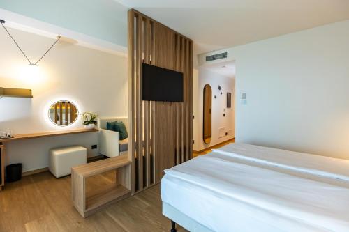 a bedroom with a large bed and a desk at Hotel Europa in Sirmione