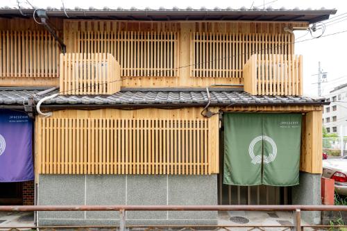 a building with wooden shutters on the side of it at JPRESERVE Hachijoguchi in Kyoto