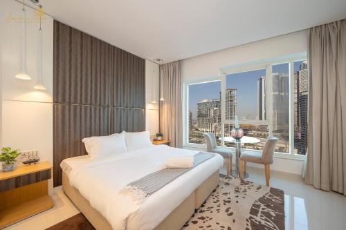 a bedroom with a bed and a large window at Cozy Canal View Studio in Dubai