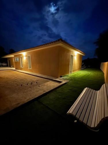 a building with a bench in front of it at night at Villa with pool in Provence in Varages