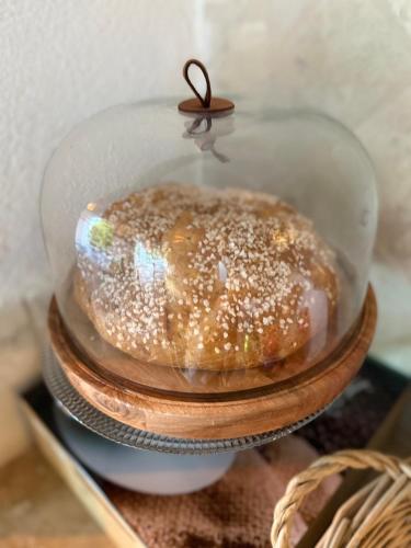 a doughnut in a glass dome on a stack of plates at La Villa Saint Jean BAS DE VILLA in La Ciotat