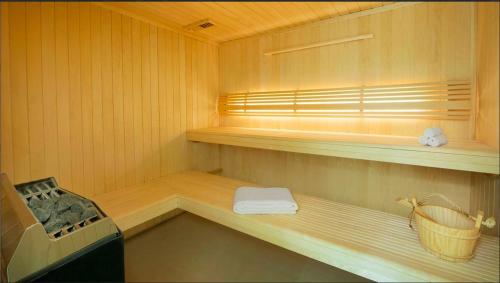 a sauna with a bench and a sink in it at Cozy Canal View Studio in Dubai